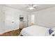 Bright bedroom with hardwood floors, a ceiling fan, and access to a closet and hallway at 506 N Greensboro St # Apt 33, Carrboro, NC 27510