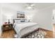 Stylishly furnished bedroom features neutral paint, modern nightstands and ceiling fan at 506 N Greensboro St # Apt 33, Carrboro, NC 27510