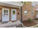Welcoming entrance with brick facade, decorative ironwork, and well-manicured landscaping at 506 N Greensboro St # Apt 33, Carrboro, NC 27510