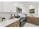 Modern kitchen featuring white cabinetry, stainless steel appliances, and beautiful countertops at 506 N Greensboro St # Apt 33, Carrboro, NC 27510