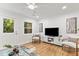 Bright living room featuring wood floors, white trim and walls, and plenty of natural light at 506 N Greensboro St # Apt 33, Carrboro, NC 27510