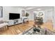 Open-concept living room with hardwood floors, stylish decor, and access to dining and kitchen areas at 506 N Greensboro St # Apt 33, Carrboro, NC 27510
