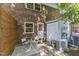 A brick patio with a privacy fence features a small table and chairs outside the back door at 506 N Greensboro St # Apt 33, Carrboro, NC 27510
