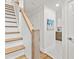 Elegant staircase with wood and white trim, leading to an upper level and hallway at 506 N Greensboro St # Apt 33, Carrboro, NC 27510