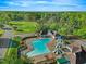 Beautiful aerial view of the community pool and nearby golf course at 5109 Windance Pl, Holly Springs, NC 27540