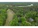Breathtaking aerial view of a home near lush greenery and a scenic lake at 5109 Windance Pl, Holly Springs, NC 27540