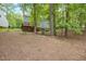 This sprawling backyard features mature trees, a rock-lined swale, and a multi-level wood deck at 5109 Windance Pl, Holly Springs, NC 27540