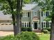 Charming two-story home with a manicured lawn and a two-car garage at 5109 Windance Pl, Holly Springs, NC 27540