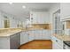 Spacious kitchen featuring granite counters, stainless steel appliances, ample cabinet space, and hardwood floors at 5109 Windance Pl, Holly Springs, NC 27540