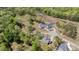 Aerial view features lush greenery, houses with well-maintained lawns, and a winding road at 5180 Glen Creek Trl, Garner, NC 27529