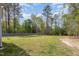 Spacious backyard with lush lawn, bordered by mature trees and wooden fencing at 5180 Glen Creek Trl, Garner, NC 27529