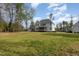 A spacious backyard featuring a well-maintained lawn and exterior view of the home at 5180 Glen Creek Trl, Garner, NC 27529