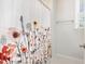 Bright bathroom featuring a floral shower curtain and neutral-colored walls with natural light at 5180 Glen Creek Trl, Garner, NC 27529