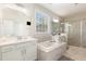 Elegant bathroom features a soaking tub, double vanity, and a glass enclosed shower at 5180 Glen Creek Trl, Garner, NC 27529