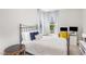 Cozy bedroom featuring an iron bed, natural light, and a dedicated workspace at 5180 Glen Creek Trl, Garner, NC 27529