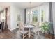 Bright dining area featuring a round table, chandelier, and large windows with backyard views at 5180 Glen Creek Trl, Garner, NC 27529