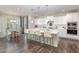 Bright, open kitchen and dining area with white cabinets, granite counters, and modern pendant lighting at 5180 Glen Creek Trl, Garner, NC 27529