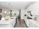 Modern kitchen with white cabinets, stainless steel appliances, a large island, and an adjacent dining area at 5180 Glen Creek Trl, Garner, NC 27529