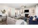 Open-concept living area with hardwood floors, a fireplace, and comfortable seating, flowing seamlessly into other living spaces at 5180 Glen Creek Trl, Garner, NC 27529