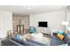 Spacious living room featuring a plush sectional sofa, and a modern coffee table at 5180 Glen Creek Trl, Garner, NC 27529