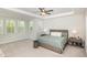Bright main bedroom with a comfortable bed, side tables, and three windows at 5180 Glen Creek Trl, Garner, NC 27529