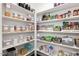 Organized walk-in pantry featuring ample shelving, clear containers, and a variety of food items at 5180 Glen Creek Trl, Garner, NC 27529