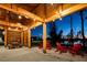 Outdoor covered patio with string lights and seating area by the water at 540 Folk Song Way, Wendell, NC 27591