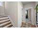 A bright hallway with wood floors, white walls, and an open staircase leads to a bedroom at 540 Folk Song Way, Wendell, NC 27591