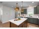 Modern kitchen with quartz countertops, custom cabinetry, and a large center island at 540 Folk Song Way, Wendell, NC 27591