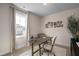 An office space with large window, neutral walls, and a modern desk at 540 Folk Song Way, Wendell, NC 27591