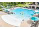 Community pool and splash pad surrounded by lounge chairs and umbrellas at 540 Folk Song Way, Wendell, NC 27591