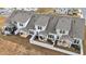 Aerial view of townhomes showcasing fenced backyards with covered patios and landscaping at 53 Whitley Ridge Dr, Clayton, NC 27527
