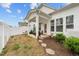 Well-maintained backyard features a covered patio, landscaped garden bed, and privacy fence at 53 Whitley Ridge Dr, Clayton, NC 27527