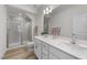 Spacious bathroom featuring double sinks, a glass-enclosed shower, and modern fixtures at 53 Whitley Ridge Dr, Clayton, NC 27527