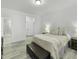 Serene bedroom with wood floors, soft lighting, and a view into the en suite bathroom at 53 Whitley Ridge Dr, Clayton, NC 27527
