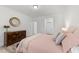 Bright bedroom features neutral walls, hardwood floors, and decorative dresser and mirror at 53 Whitley Ridge Dr, Clayton, NC 27527