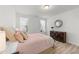 Comfortable bedroom featuring large windows, hardwood floors, and a modern dresser at 53 Whitley Ridge Dr, Clayton, NC 27527