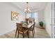 Bright dining room showcasing a wood table, tray ceiling, chandelier, and natural light at 53 Whitley Ridge Dr, Clayton, NC 27527