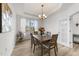 Elegant dining room features wood floors, a chandelier, and a view to the outside at 53 Whitley Ridge Dr, Clayton, NC 27527