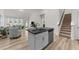 Open kitchen layout with island seating, seamlessly connecting to the living area and staircase at 53 Whitley Ridge Dr, Clayton, NC 27527