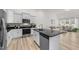 Modern kitchen featuring stainless steel appliances, white cabinets, and black countertops at 53 Whitley Ridge Dr, Clayton, NC 27527