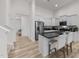 Bright, modern kitchen with white cabinetry, granite countertops, stainless steel appliances, and a breakfast bar at 53 Whitley Ridge Dr, Clayton, NC 27527
