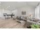 Open-concept living room and kitchen with modern finishes, including wood floors and stainless steel appliances at 53 Whitley Ridge Dr, Clayton, NC 27527