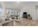 Inviting living room featuring hardwood floors, neutral furniture, and a vaulted ceiling at 53 Whitley Ridge Dr, Clayton, NC 27527