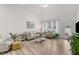 Inviting living room with large windows, hardwood floors, neutral furniture, and bright, natural light at 53 Whitley Ridge Dr, Clayton, NC 27527