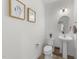 Chic powder room with pedestal sink, decorative artwork, and modern fixtures at 53 Whitley Ridge Dr, Clayton, NC 27527