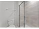 Modern bathroom featuring a tiled shower with glass door and a sleek toilet, creating a clean and functional space at 5432 Crescent Square St, Raleigh, NC 27616