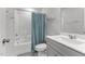 Bathroom with tile floors, shower-tub combo and a single sink vanity at 5432 Crescent Square St, Raleigh, NC 27616