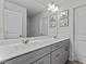 Bright bathroom featuring double sinks, a large mirror, and white cabinets for ample storage space at 5432 Crescent Square St, Raleigh, NC 27616
