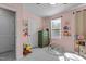bedroom featuring pink walls, a green dresser, and lots of toys for a playful atmosphere at 5432 Crescent Square St, Raleigh, NC 27616